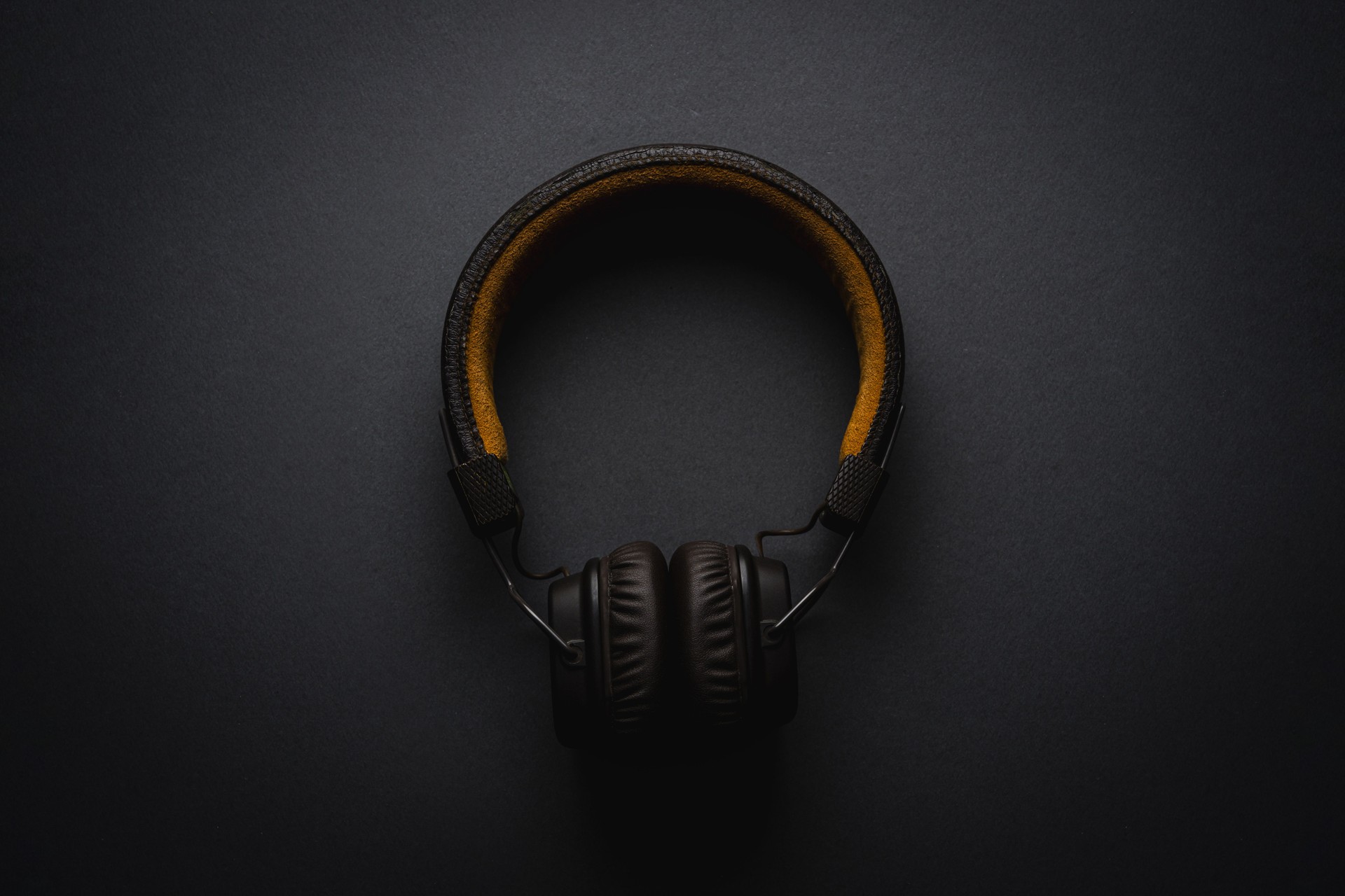 Retro style wireless over-ear headphones on dark gray background